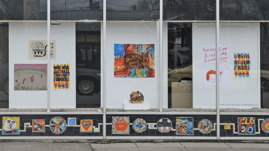 Installation View of an exhibition including ceramics, prints, paintings, and mixed media works in NIAD Windows, My Rising Special Place selected by Mary Mortimer and Dorrie Reid