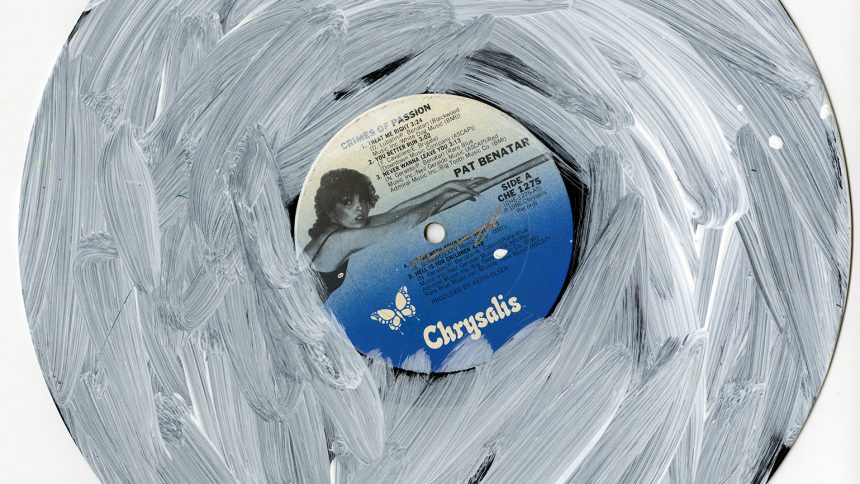 A vinyl record by Pat Benatar, Crimes of Passion, is overlaid with white acrylic paint by NIAD Studio Artist Christian Vassell.