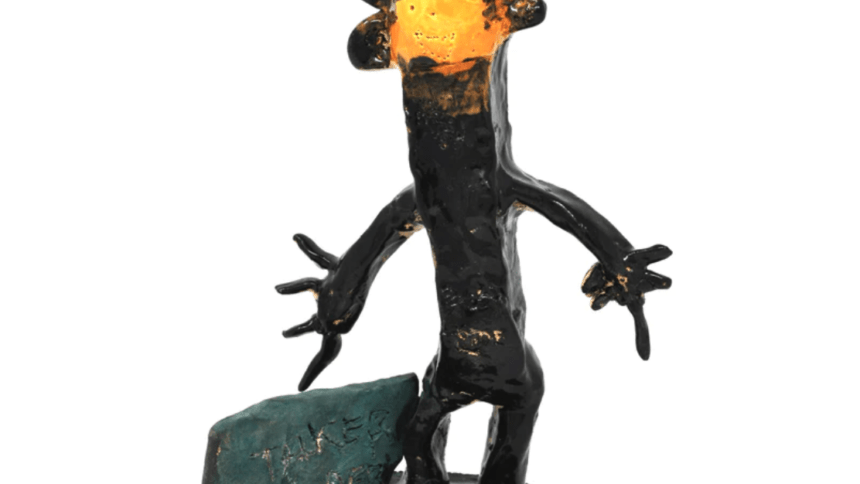 a ceramic figure glazed in black and orange